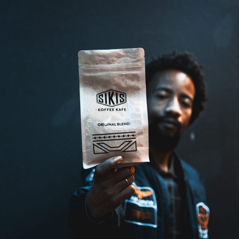 Phuso holding a bag of Sikis Coffee Original Blend