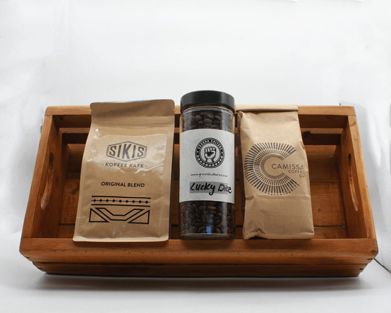 Coffee Bundle in a brown wooden basket with three different coffees with a white background